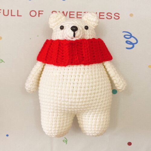 Cute white polar bear with red scarf