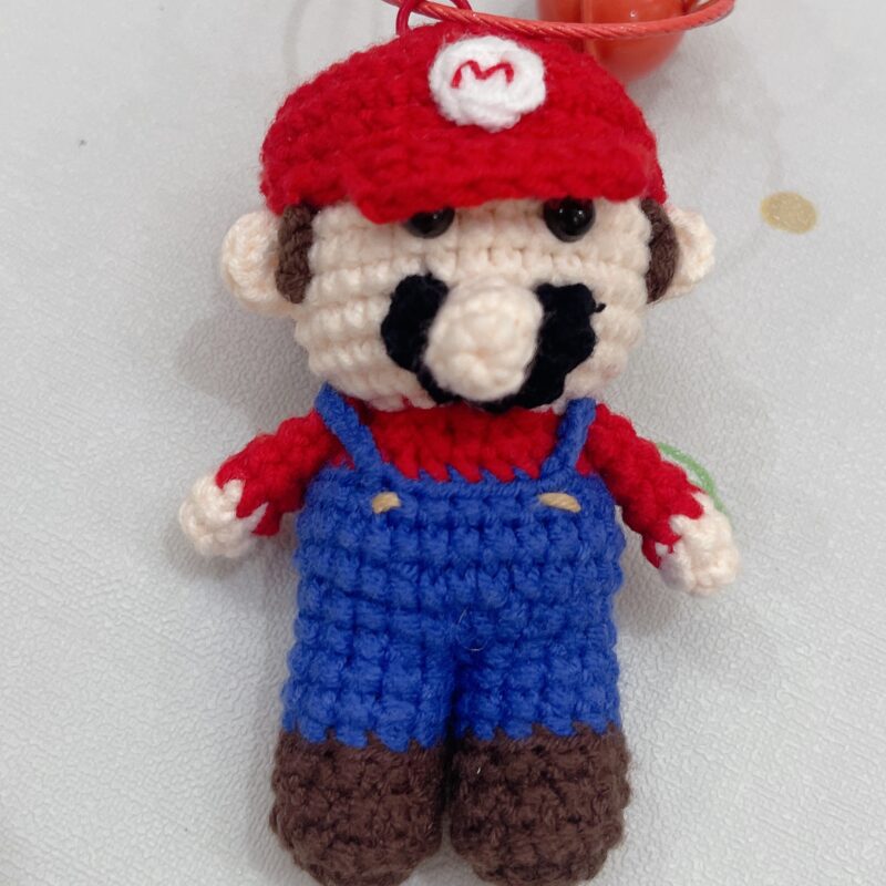 Handmade crocheted Mario dolls that can be used as ornaments or as key chains and pendants!